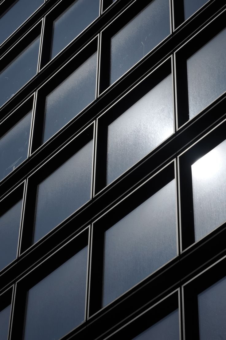 Structured glass façade used as a visual metaphor for operating systems